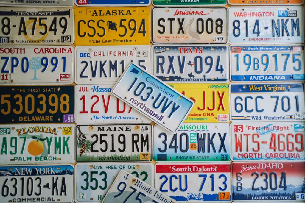 a colorful collage of vintage US license plates